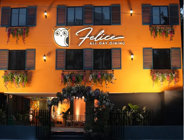 The new Felice All Day Dining building, lit orange at dusk